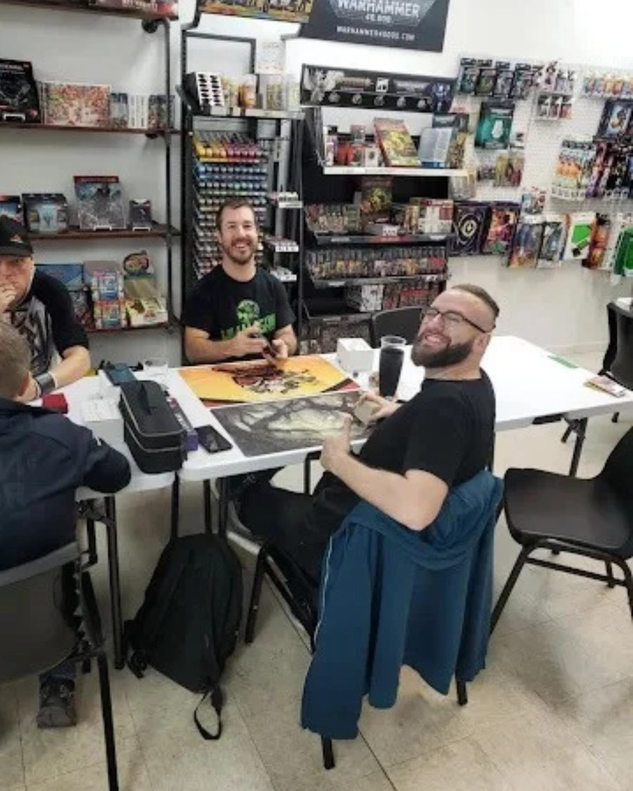Seb plays a game of Warhammer with customers at Café Ork'n'Roll